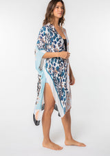 [Color: Lt Blue/Sand] A model wearing a stunning mid length kimono in a light blue mixed floral print. Featuring half length kimono sleeves, side slits, and an open front.