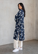 [Color: Navy/Ivory] A model wearing a bohemian navy blue mid length kimono with floral embroidery. 