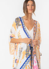 [Color: Sunkist/Off White] A model wearing a blue and yellow mixed bohemian print kimono. 