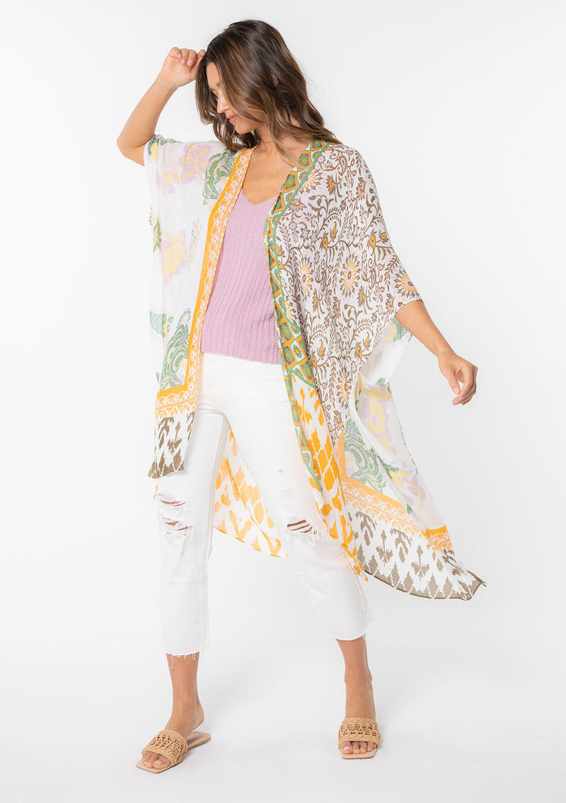 [Color: Taupe/Off White] A model wearing a yellow and white mixed bohemian print kimono. 