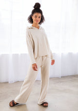 [Color: Seashell] A model wearing a seashell beige pull on style wide leg jogger pant made with soft French terry. With a drawstring waist and essential side pockets.