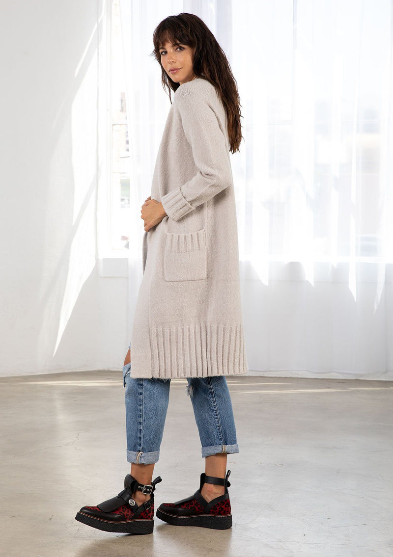 [Color: Light Taupe] Dreamy mid length cardigan. Featuring an easy open front, essential front patch pockets, and contrast ribbed trim detail. The cozy shawl neckline rounds out this comfortable yet flattering sweater.