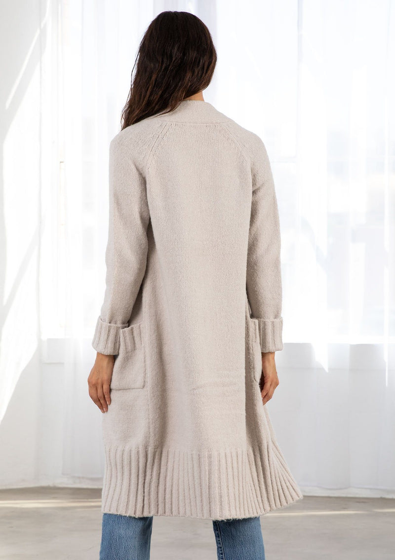 [Color: Light Taupe] Dreamy mid length cardigan. Featuring an easy open front, essential front patch pockets, and contrast ribbed trim detail. The cozy shawl neckline rounds out this comfortable yet flattering sweater.