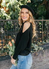 [Color: Black] A girl wearing a black oversized cozy pullover sweater.