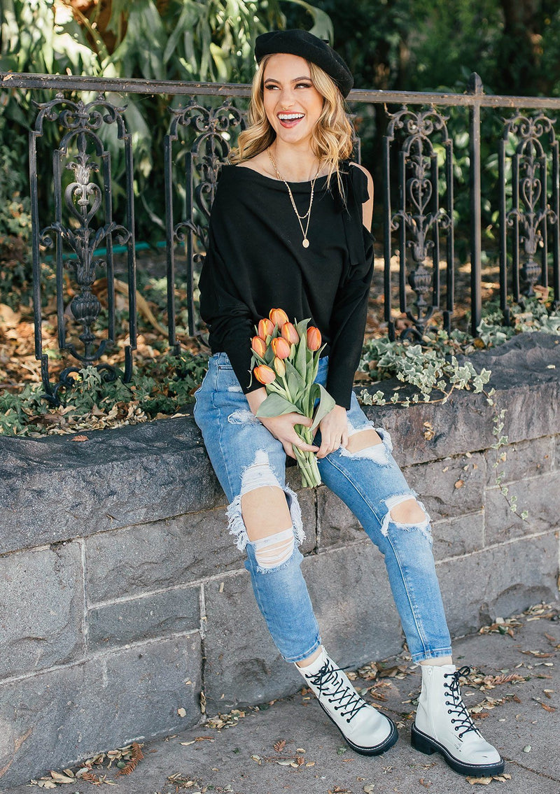 [Color: Black] A girl wearing a black oversized cozy pullover sweater.