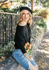 [Color: Black] A girl wearing a black oversized cozy pullover sweater.