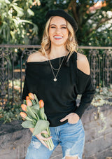 [Color: Black] A girl wearing a black oversized cozy pullover sweater.