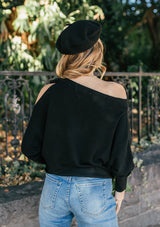 [Color: Black] A girl wearing a black oversized cozy pullover sweater.