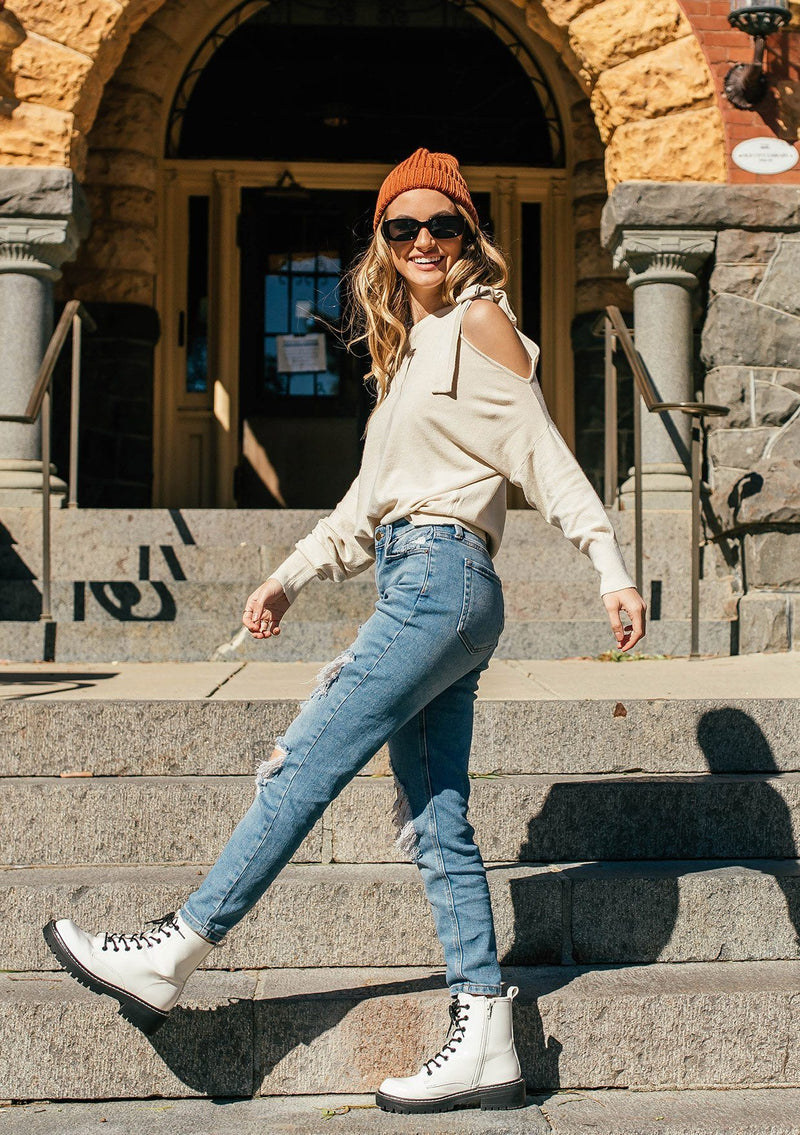 [Color: Vanilla] A girl wearing a white oversized cozy pullover sweater.