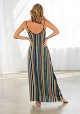 [Color: Black/Multi] A model wearing a multi color striped bohemian maxi dress. With a tie front detail, adjustable spaghetti straps, and side pockets. 