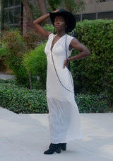 [Color: Off White] A woman wearing a sheer off white chiffon swiss dot maxi dress. With a drawstring empire waist, tiered skirt, v neckline, and lining.