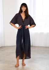 [Color: Navy/Blue] A bohemian maxi dress in a gradient stripe print. With half length kimono sleeves, a deep v neckline, a front slit, and a front knot detail at the waist. 