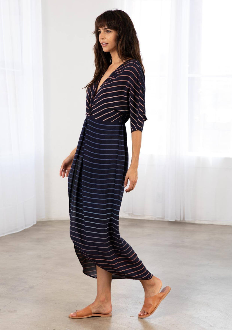 [Color: Navy/Blue] A bohemian maxi dress in a gradient stripe print. With half length kimono sleeves, a deep v neckline, a front slit, and a front knot detail at the waist. 