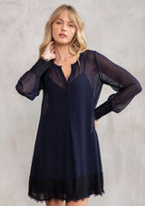 [Color: Navy/Black] A model wearing a sophisticated navy and black sheer chiffon mini dress, perfect for holiday parties. With a pretty lace trim hemline and wrist cuffs. 