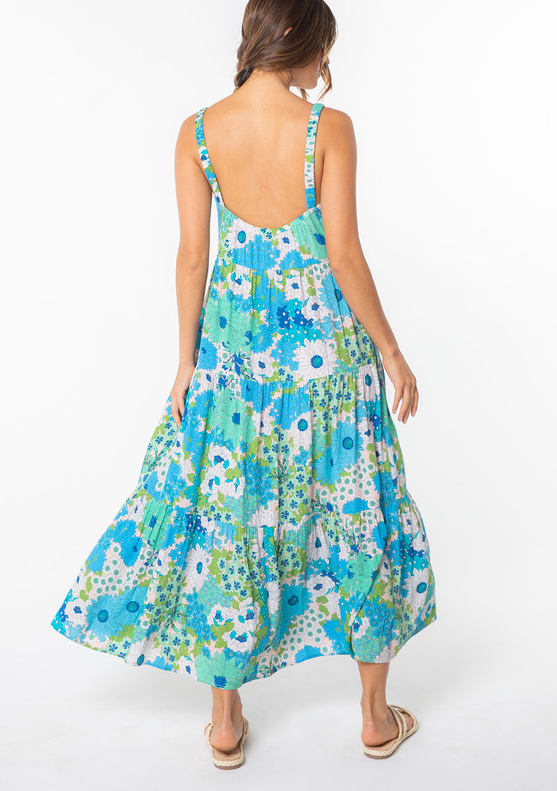 [Color: Green/Aqua] A model wearing a flowy bohemian maxi tank dress in a bright green and blue retro floral print. 