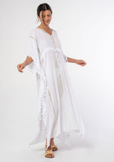 [Color: White] A woman wearing a sheer white bohemian beach cover up maxi dress with lace and tassel trim and side slits. A kimono kaftan maxi dress perfect for vacations! 