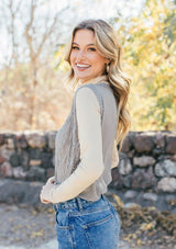 [Color: Light Grey] Girl wearing a tan crochet sweater vest 