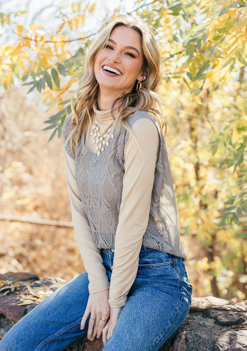 [Color: Light Grey] Girl wearing a tan crochet sweater vest 