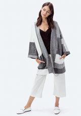 [Color: Heather Grey/Ivory] A full body image of a brunette model wearing an ultra cozy color block cardigan in grey. Featuring wide long sleeves, dropped shoulders, an open front, and rib accents throughout. Perfect for Fall layering. 