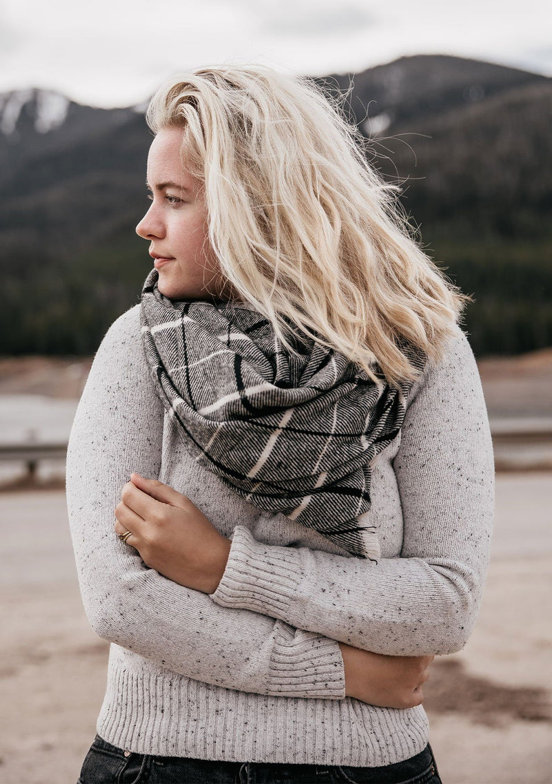 [Color: Black/Grey] Wrap yourself up in this cozy, oversized plaid scarf wrap with mini fringe trim. A classic style that pairs effortlessly with everything.