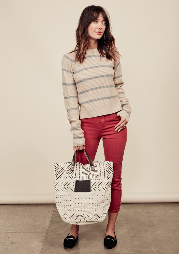 [Color: Oatmeal/Light Heather Grey] A brunette model wearing a stripe knit pullover sweater with long sleeves, a  crew neckline, and side vents. The perfect throw on for casual outings. 