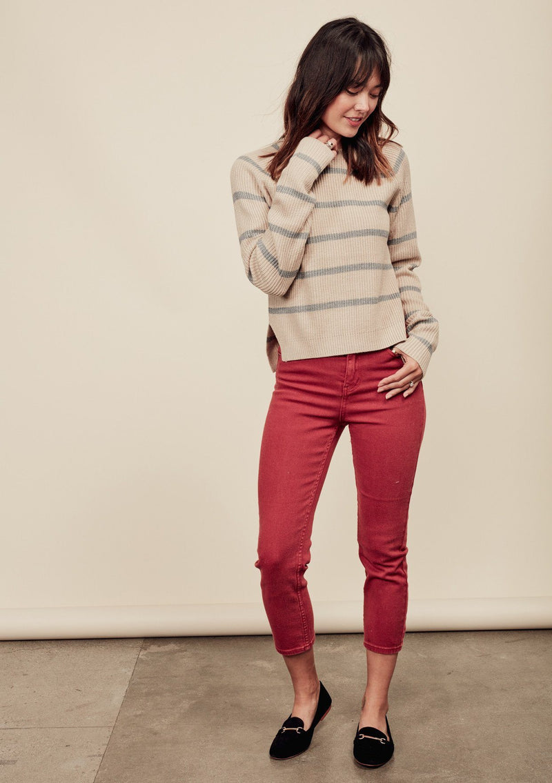 [Color: Oatmeal/Light Heather Grey] A brunette model wearing a stripe knit pullover sweater with long sleeves, a  crew neckline, and side vents. The perfect throw on for casual outings. 