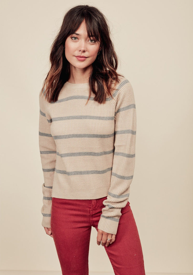 [Color: Oatmeal/Light Heather Grey] A brunette model wearing a stripe knit pullover sweater with long sleeves, a  crew neckline, and side vents. The perfect throw on for casual outings. 